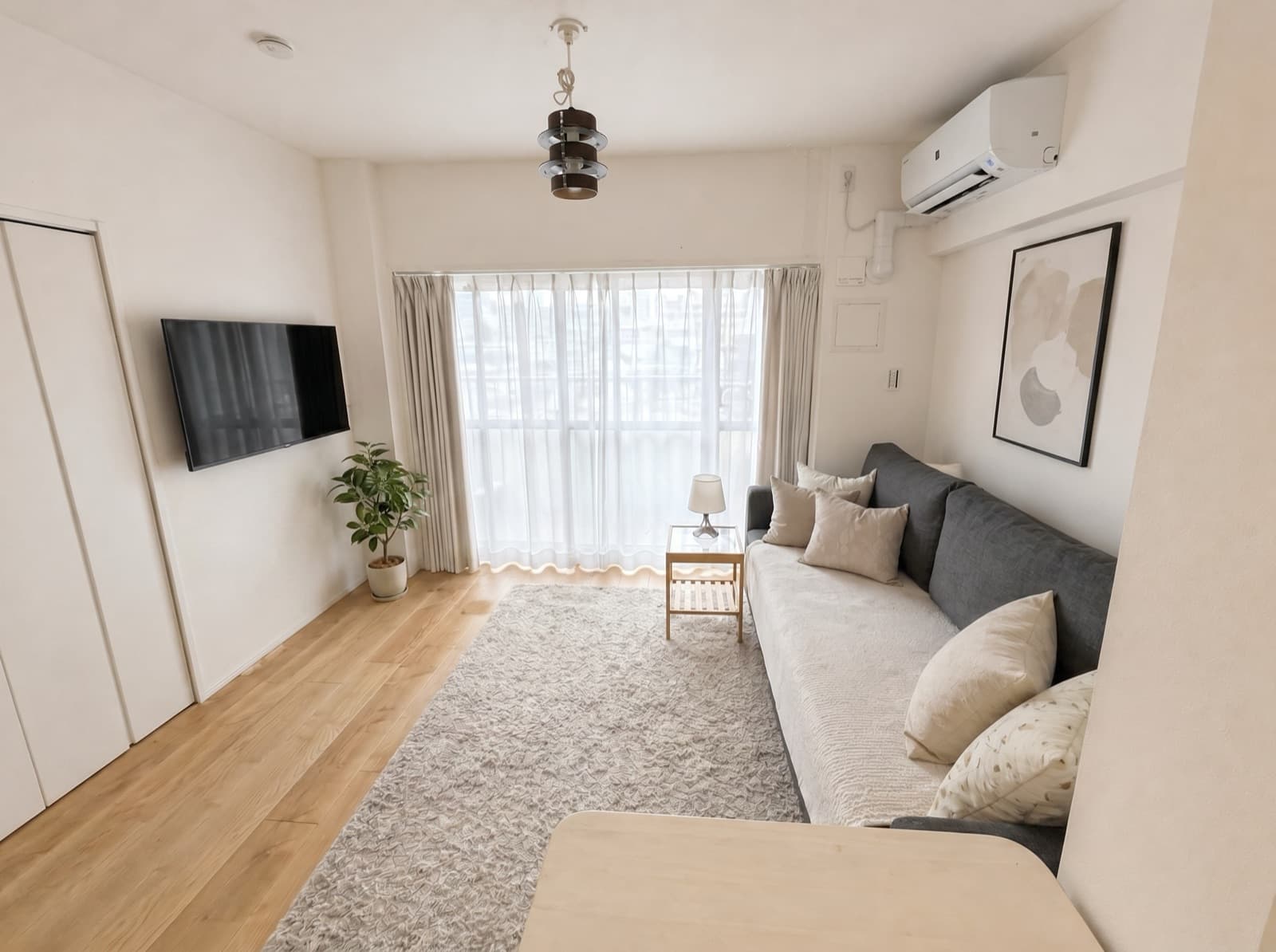 HalfKey furnished living room with grey sofa and balcony